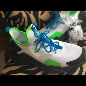 White, blue, lime green and black Nike Huaraches